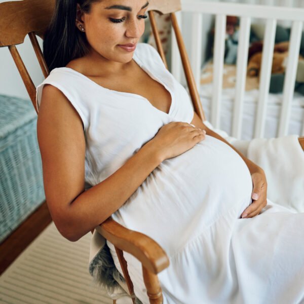 Trudnica opušteno sjedi u ljuljački – trenutak mira i opuštanja.